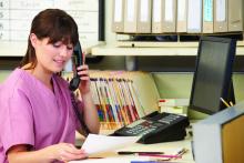 Nurse Making Phone Call At Nurses Station